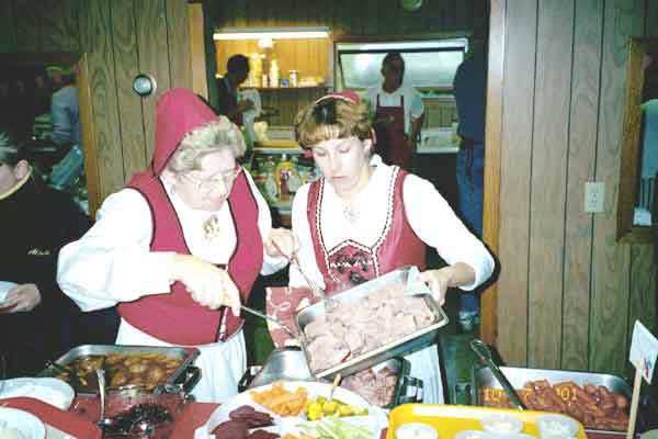 Two women from our church in Norwegian costumes working at the smorgasbord.