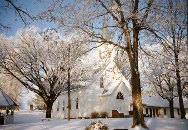 Wintry photo of the church which also shows the gazebo on the left.