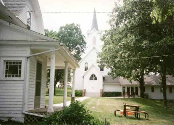 The north side of the parsonage showing the front of the church in the background.
