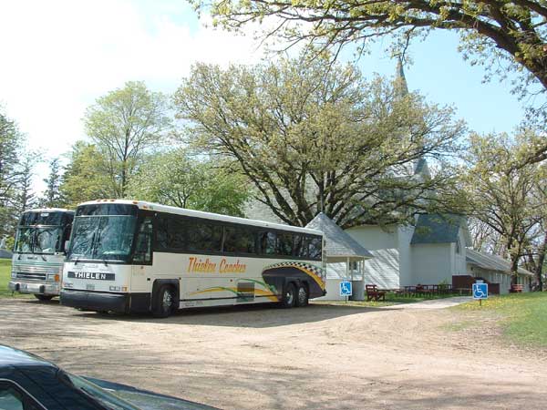 Buses arrive for the Syttende Mai dinner.