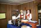 Two women in Norwegian costumes waiting to serve